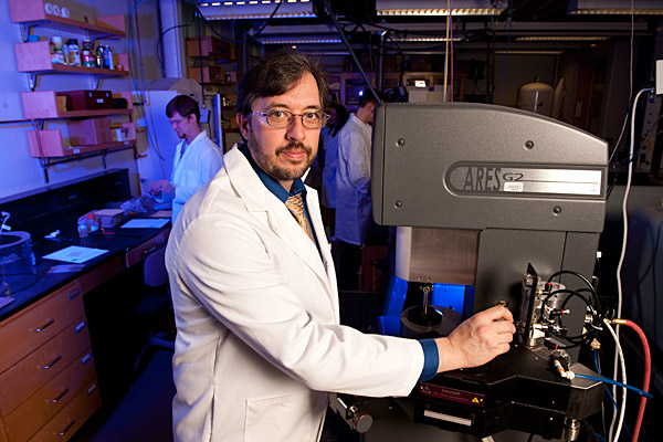 man in lab coat with lab equipment