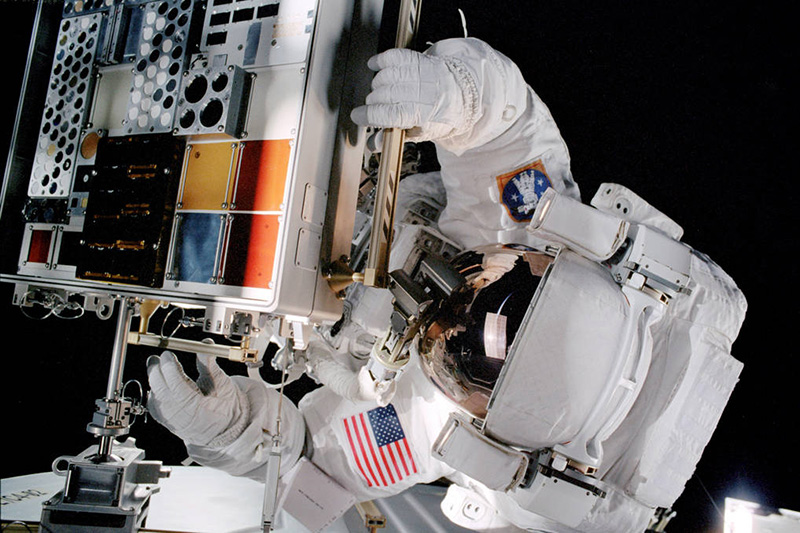 Astronaut working with the Materials International Space Station Experiment (MISSE). Credit: NASA/MSFC